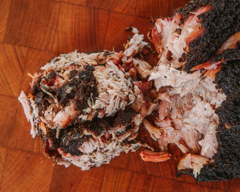 Pork shoulder pulled apart on the board