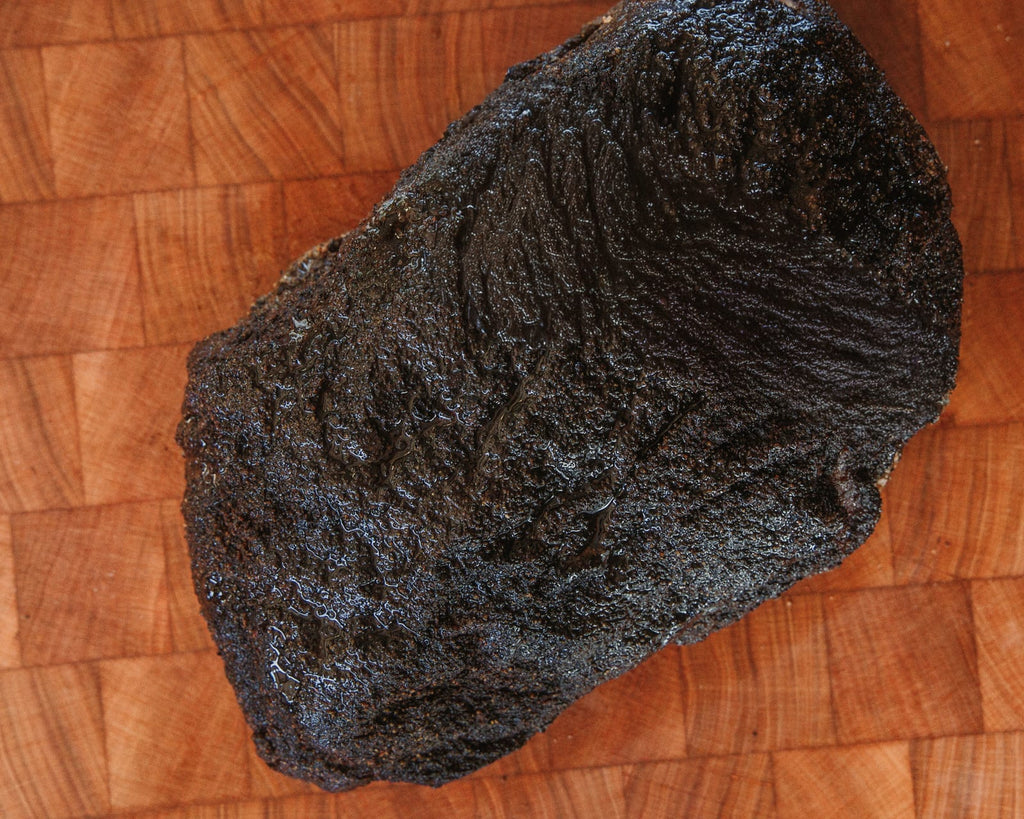 Whole smoked pork shoulder with a dark bark