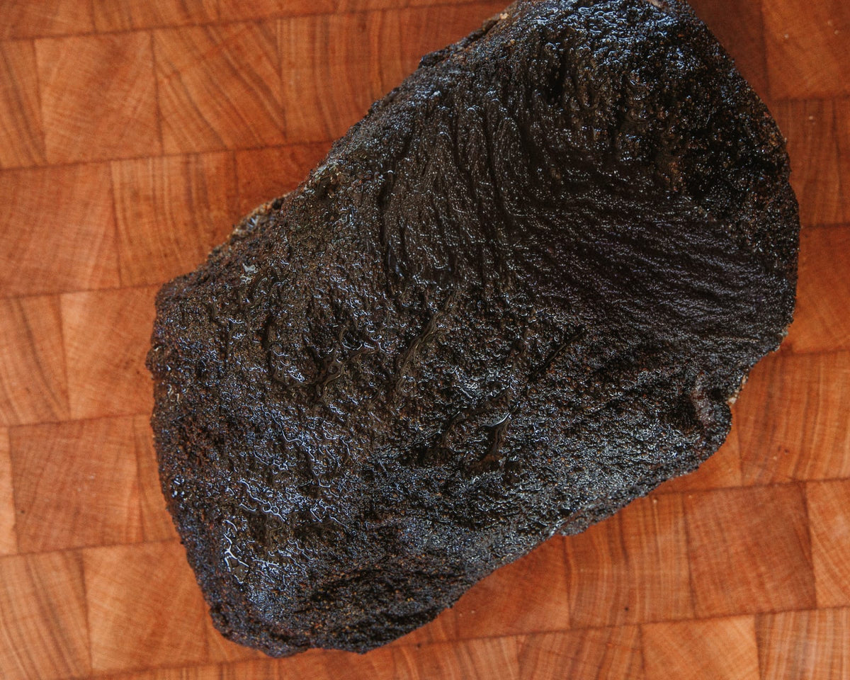 Whole smoked pork shoulder with a dark bark