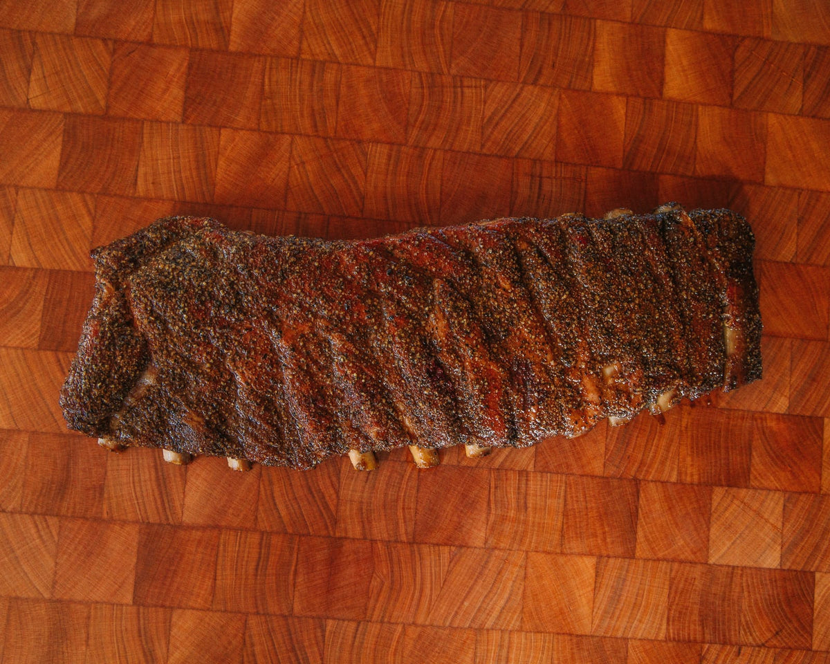 A full rack of St. Louis pork ribs, glazed