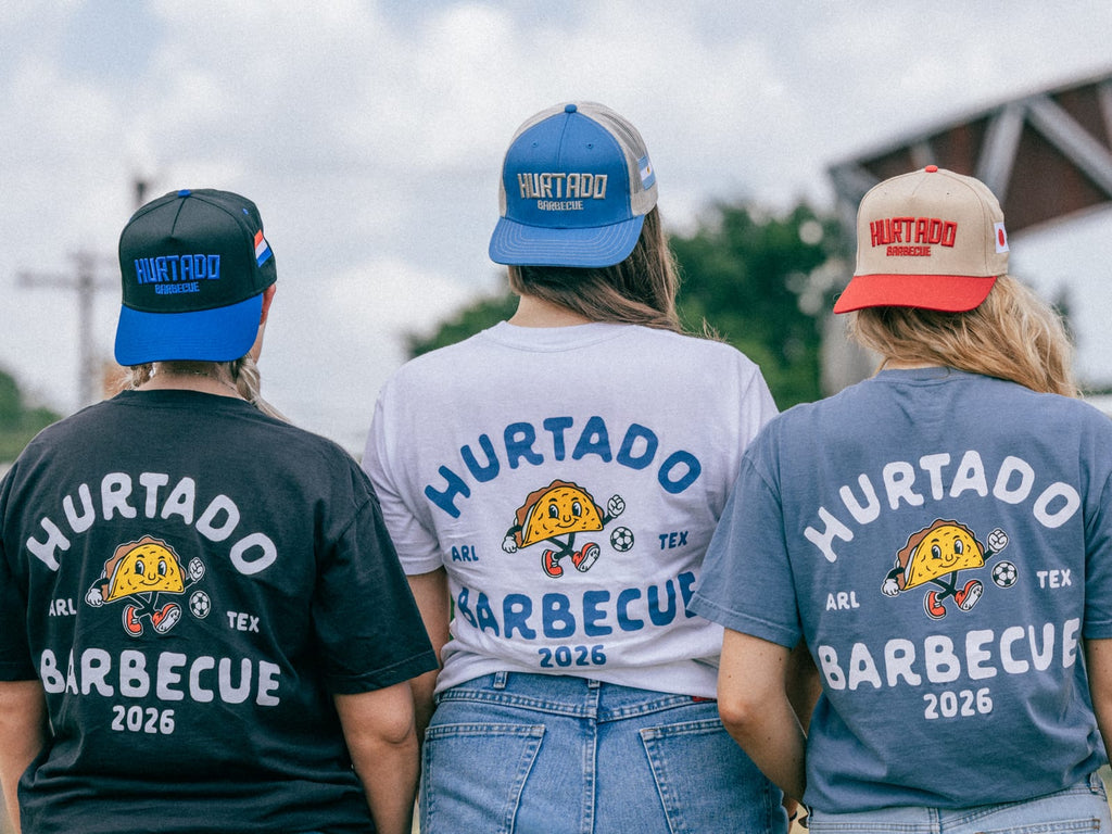 Hurtado Barbecue soccer tee lineup, three colorways from behind showing the full back badge
