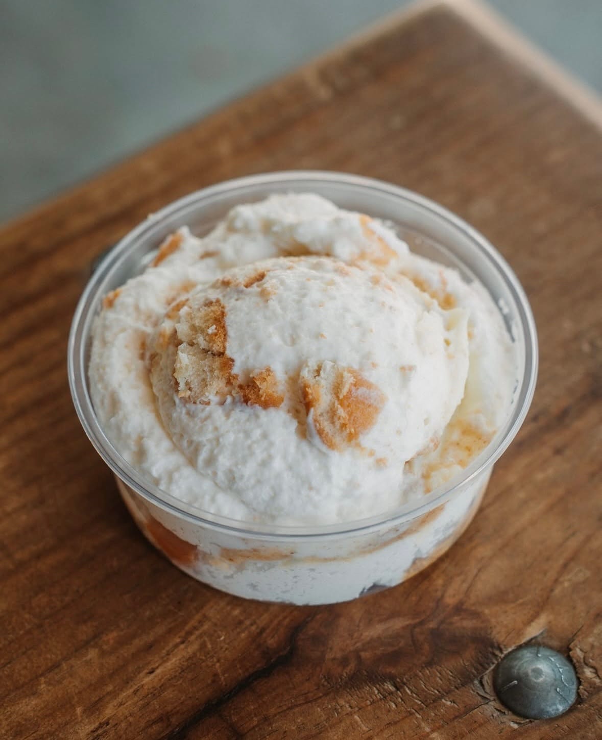 A container of tres leches banana pudding on a cutting board